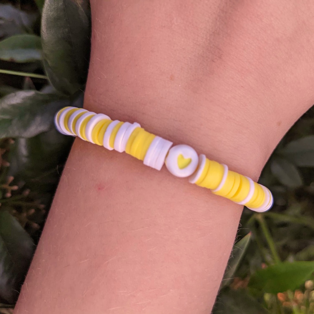 This clay bead bracelet with is made with yellow and white  clay beads.